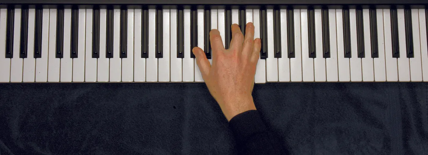 Abdim7 chord played on a piano — hand position on the keys