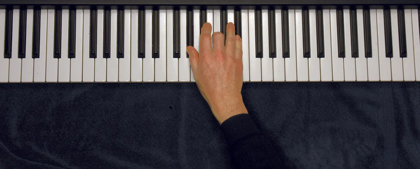 Ab chord played on a piano — hand position on the keys