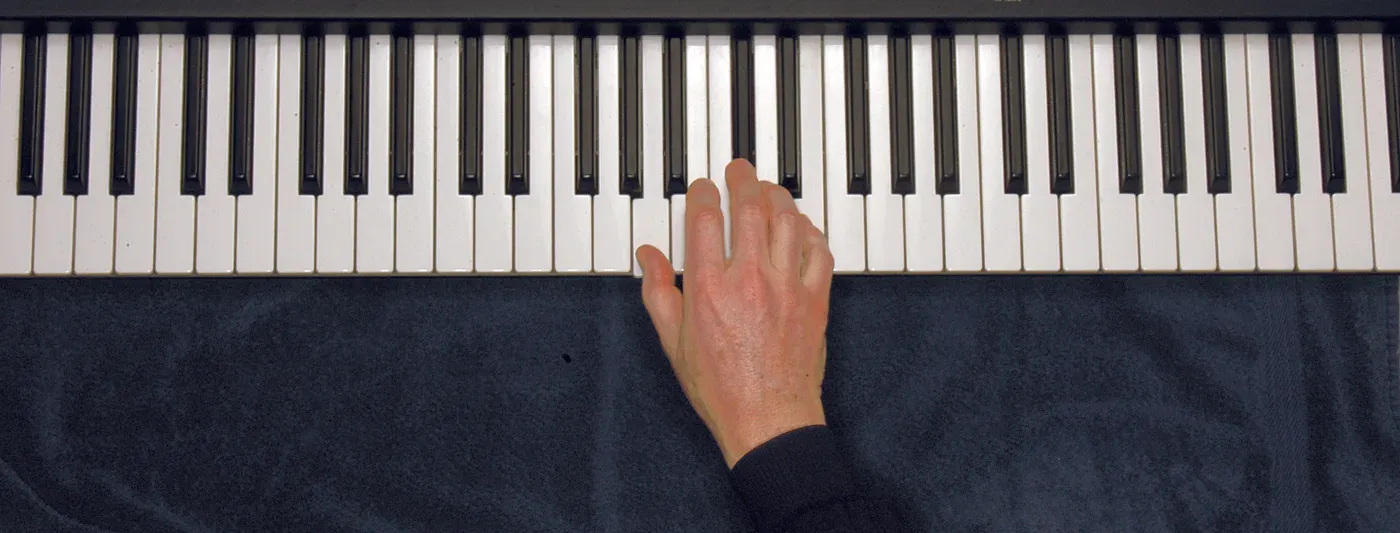 A chord played on a piano — hand position on the keys