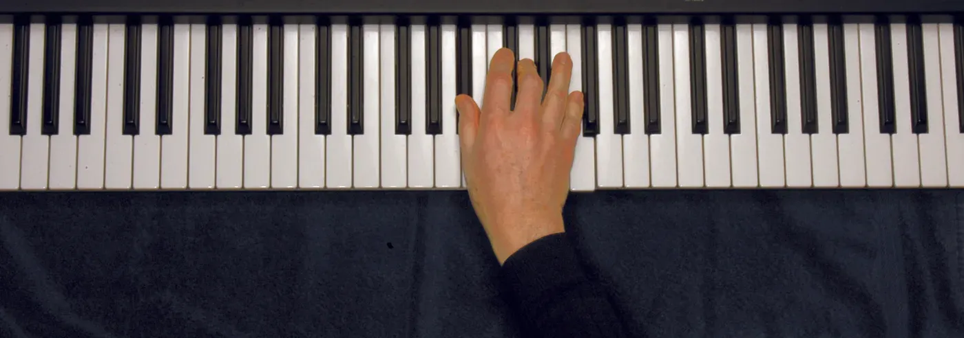 Bb chord played on a piano — hand position on the keys
