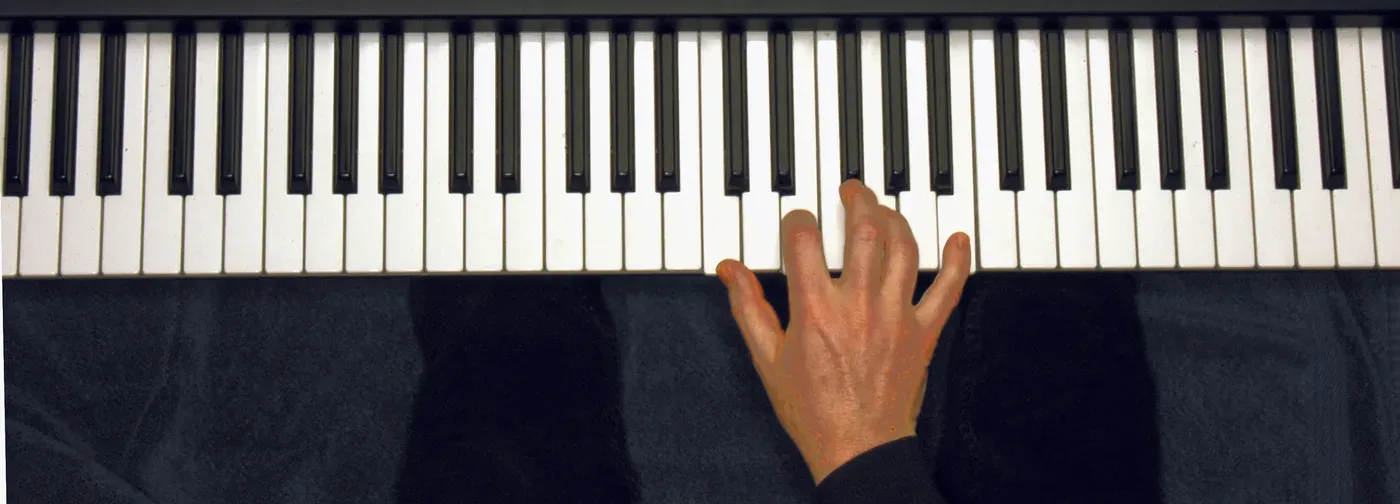 Cmaj7 chord played on a piano — hand position on the keys