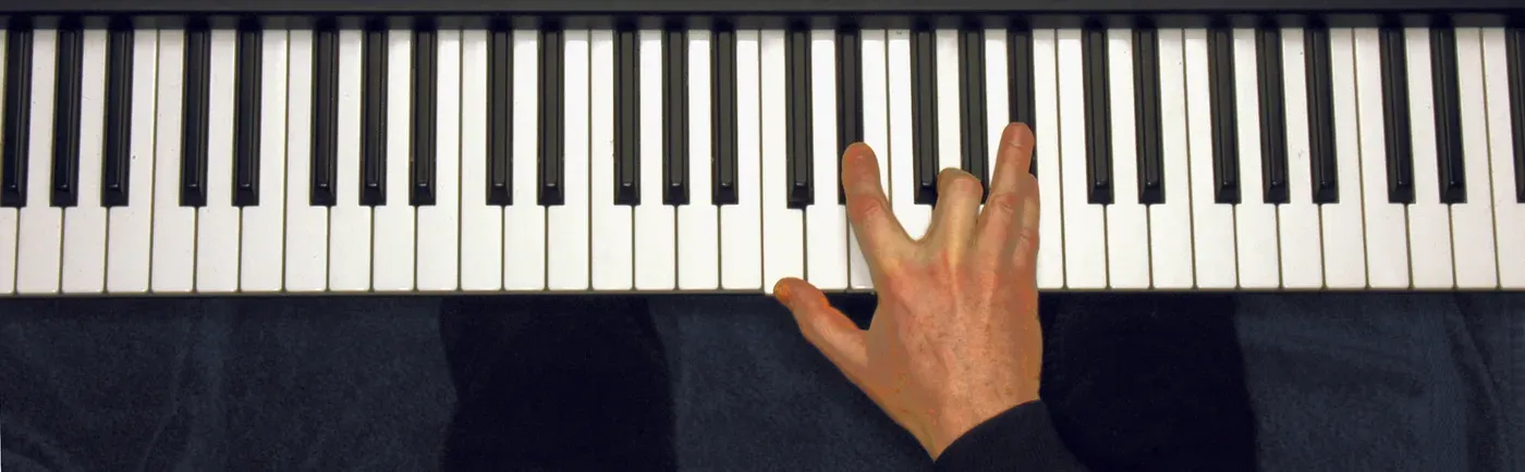 Cm7 chord played on a piano — hand position on the keys