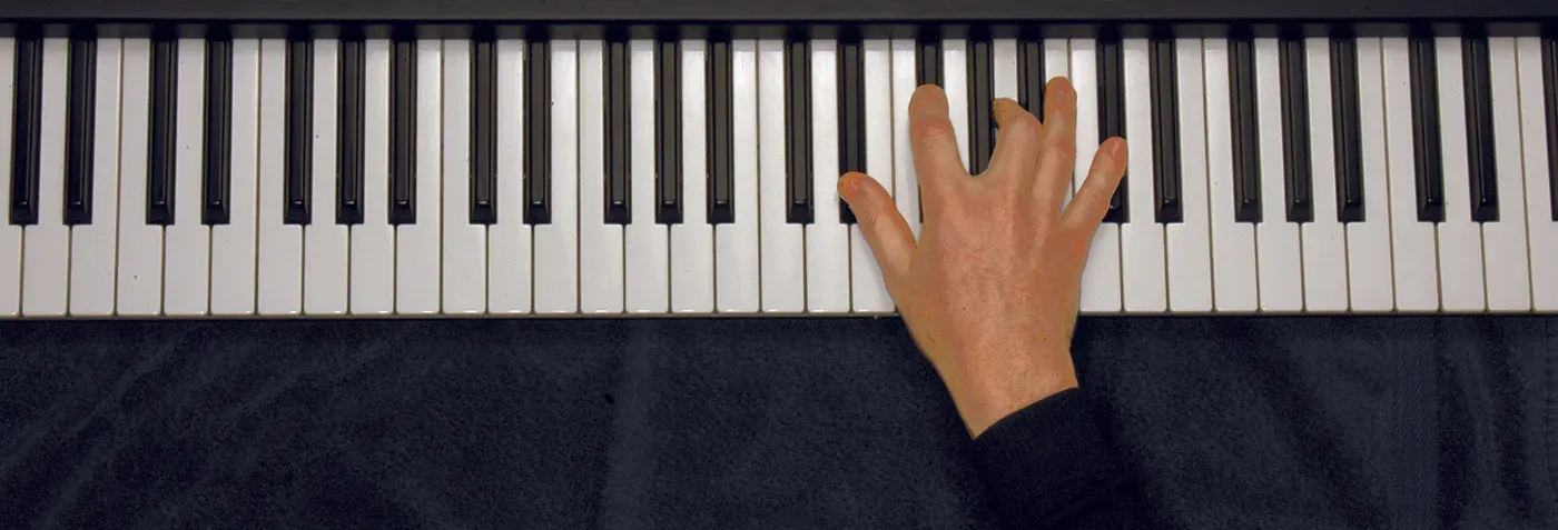 Ebm7b5 chord played on a piano — hand position on the keys