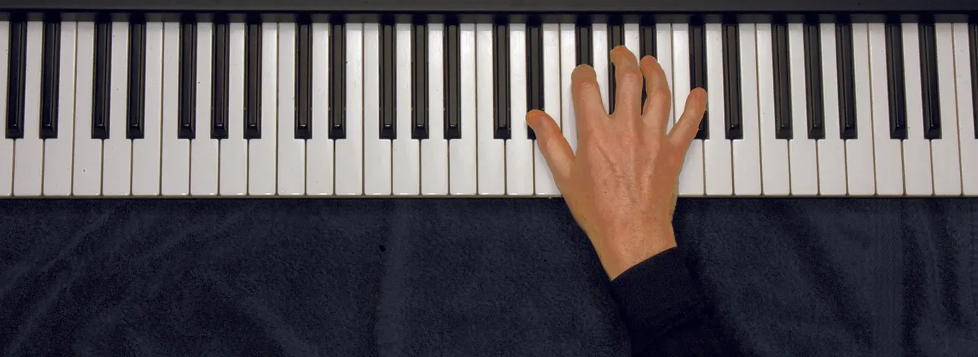 Ebm7 chord played on a piano — hand position on the keys