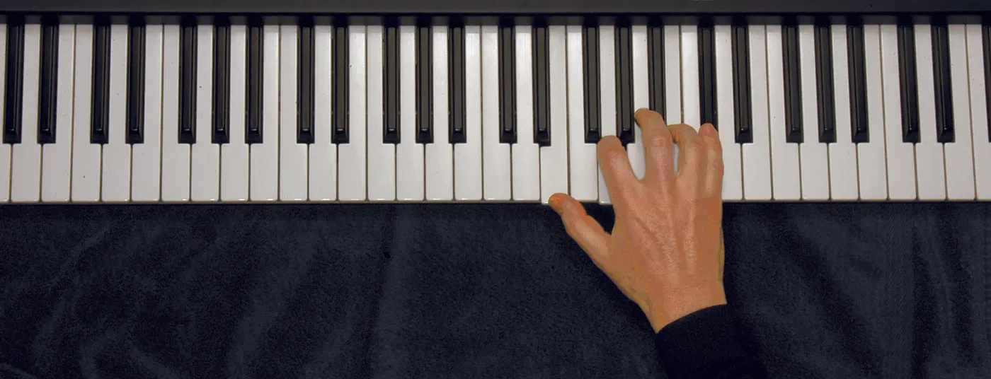 Em7b5 chord played on a piano — hand position on the keys