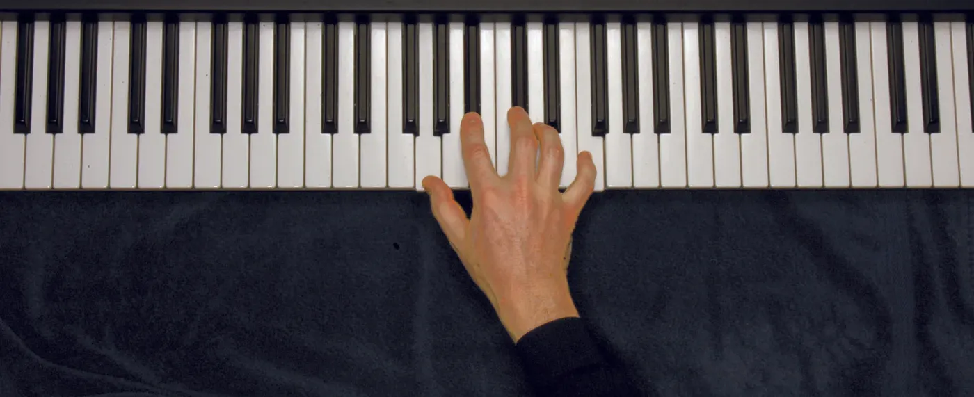 Gm7b5 chord played on a piano — hand position on the keys